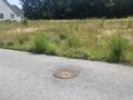 COUNTRY GROVE SUBDIVISION LOTS VIEW OF SEWER MANHOLE AND LOT #83